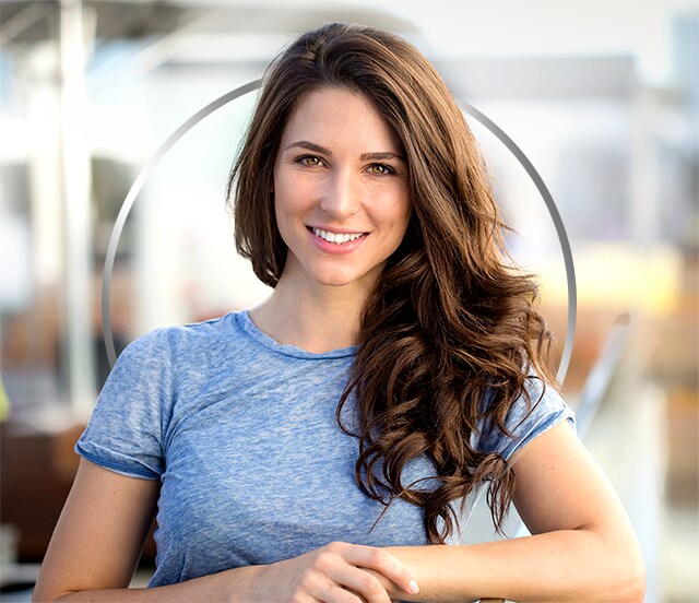 Young smiling woman with brown hair in confident pose 