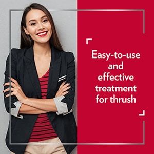 Smiling young woman wearing smart clothes with her arms crossed, happy after Canesten treatment, with the caption Easy-to-use and effective treatment for thrush