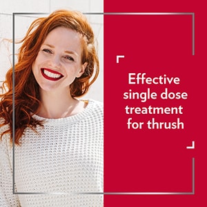 Smiling red-haired woman, with the caption Effective single dose treatment for thrush 